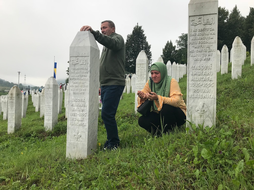 (Photo courtesy of Ermina Mustafic-Harambasic) Ermina Mustafic-Harambasic's mother and father stand at her uncle's and grandfather's graves in Potocari, Bosnia.