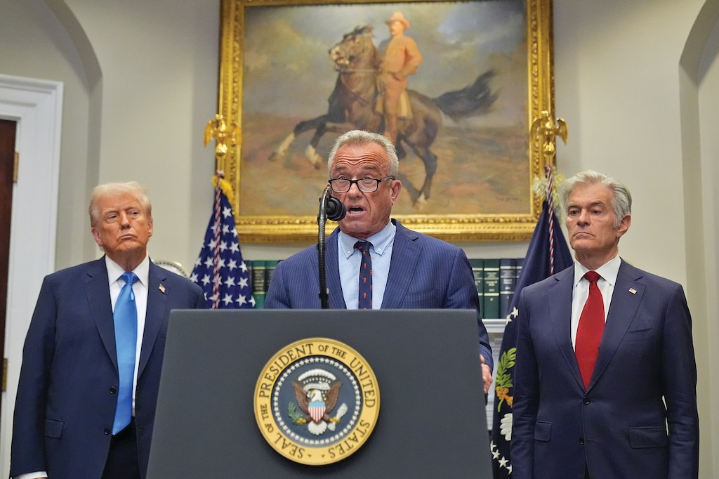 President Donald Trump and Centers for Medicare & Medicaid Services administrator Dr. Mehmet Oz listen as Health and Human Services Secretary Robert F. Kennedy Jr. speaks in the Roosevelt Room of the White House, Monday, Sept. 22, 2025, in Washington. (AP Photo/Mark Schiefelbein)