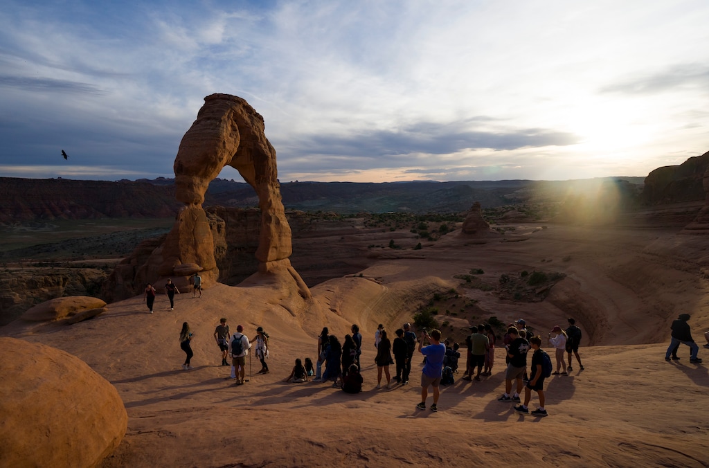 (Bethany Baker  |  The Salt Lake Tribune) People line up to take a photo under Delicate Arch inside Arches National Park near Moab on Thursday, April 9, 2026.