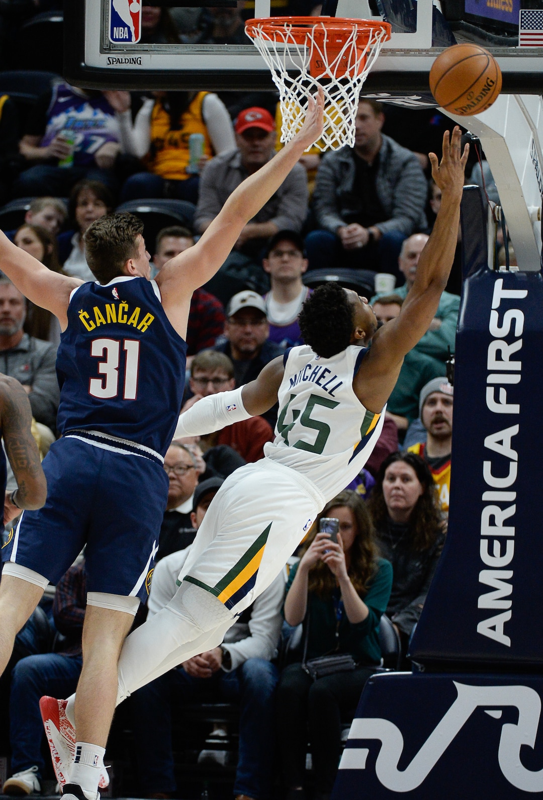 (Francisco Kjolseth  |  The Salt Lake Tribune) Utah Jazz guard Donovan Mitchell (45) tries to arch one in past Denver Nuggets forward Vlatko Cancar (31) as the Utah Jazz host the Denver Nuggets in their NBA basketball game at Vivint Smart Home Arena in Salt Lake City on Wednesday, Feb. 5, 2020.