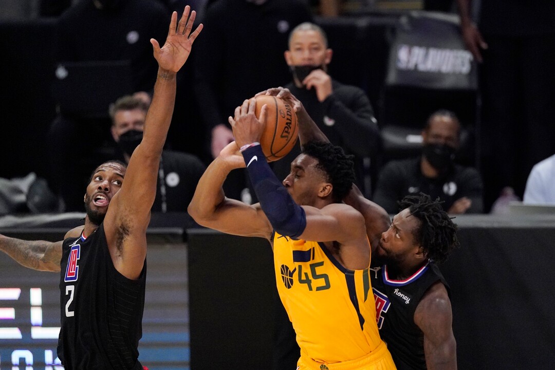 Utah Jazz guard Donovan Mitchell, center, has his shot blocked by Los Angeles Clippers guard Patrick Beverley, right, as forward Kawhi Leonard defends during the first half in Game 4 of a second-round NBA basketball playoff series Monday, June 14, 2021, in Los Angeles. (AP Photo/Mark J. Terrill)