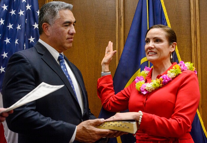 (Steve Griffin | The Salt Lake Tribune) As her husband Steve Kaufusi holds the Bible Michelle Kaufusi takes the Oath of Office as she becomes the first female mayor in Provo city's history. The small private ceremony was held in the Mayor's Office in Provo Tuesday January 2, 2018. A public Inauguration Ceremony for Mayor Kaufusi will be held at the Provo Library on January 18, 2018.