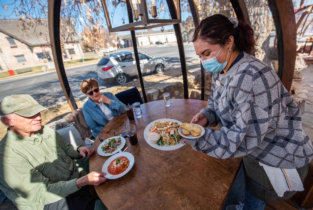 (Francisco Kjolseth  |  The Salt Lake Tribune) Briana Payan serves lunch to John and Suzi Nielsen as they try out one of three dome-like Alpenglobes at Cafe Galleria in Midway on Thursday, Nov. 5, 2020.