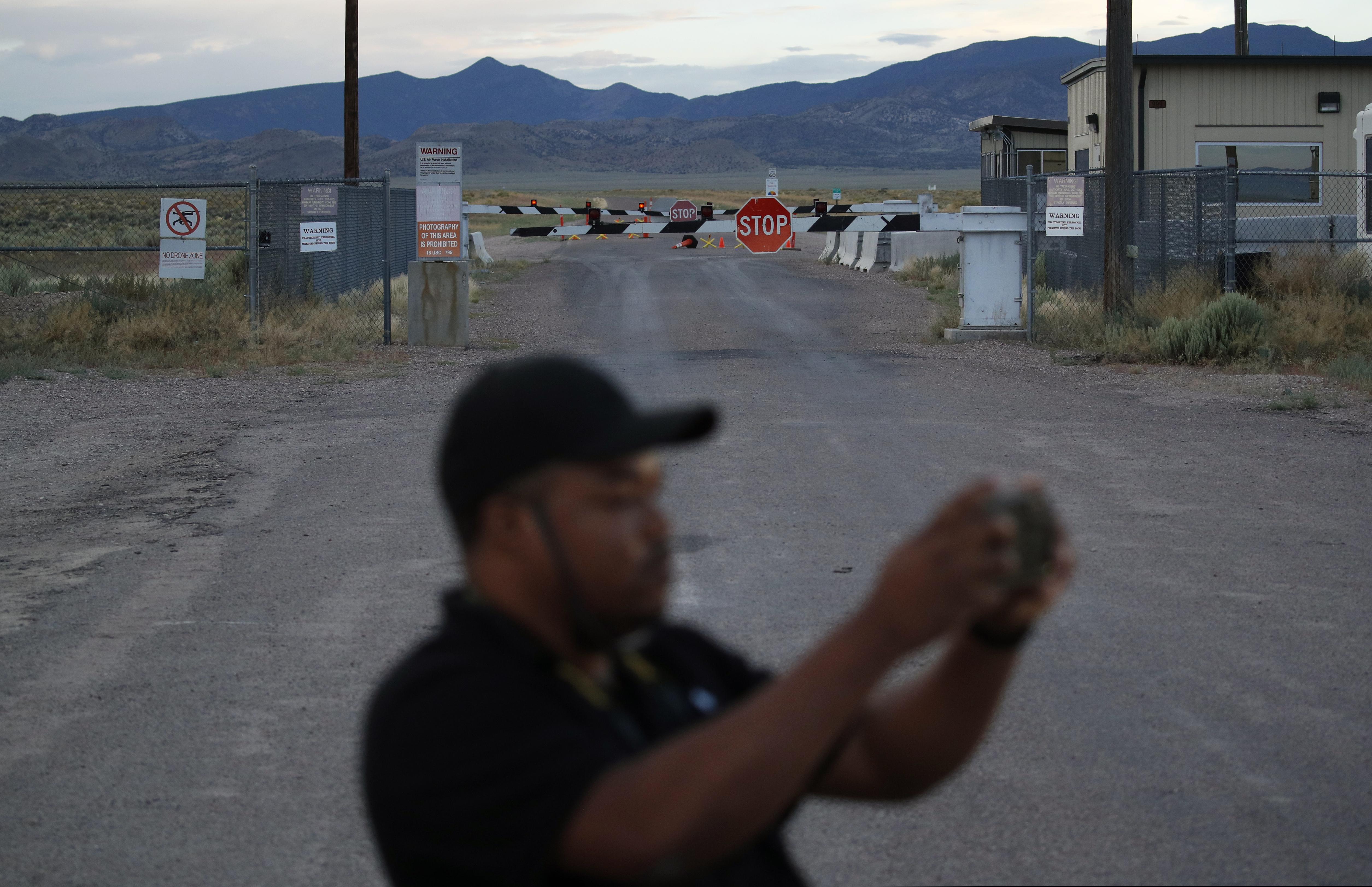 (John Locher | AP Photo) In this July 22, 2019 photo, Terris Williams visits an entrance to the Nevada Test and Training Range near Area 51 outside of Rachel, Nev. The U.S. Air Force has warned people against participating in an internet joke suggesting a large crowd of people "storm Area 51," the top-secret Cold War test site in the Nevada desert.