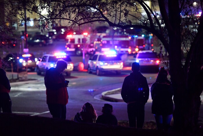 People watch police activity at the scene of a shooting inside Walmart, Wednesday, Nov. 1, 2017, in Thornton, Colo. Thornton police tweeted Wednesday night that they were responding to a shooting with "multiple parties down." They advised people to stay away from the area as dozens of police cruisers and emergency vehicles raced to the scene. (Helen H. Richardson/The Denver Post via AP)