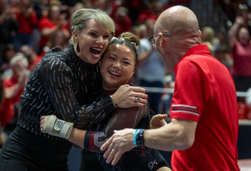 (Rick Egan | The Salt Lake Tribune) Utah head Carly Dockendorf hugs Zoe Johnson after her vault as assistant coach Mike Hunger looks on, in the NCAA gymnastics regional finals at the Jon M. Huntsman Center on Saturday, April 5, 2025.