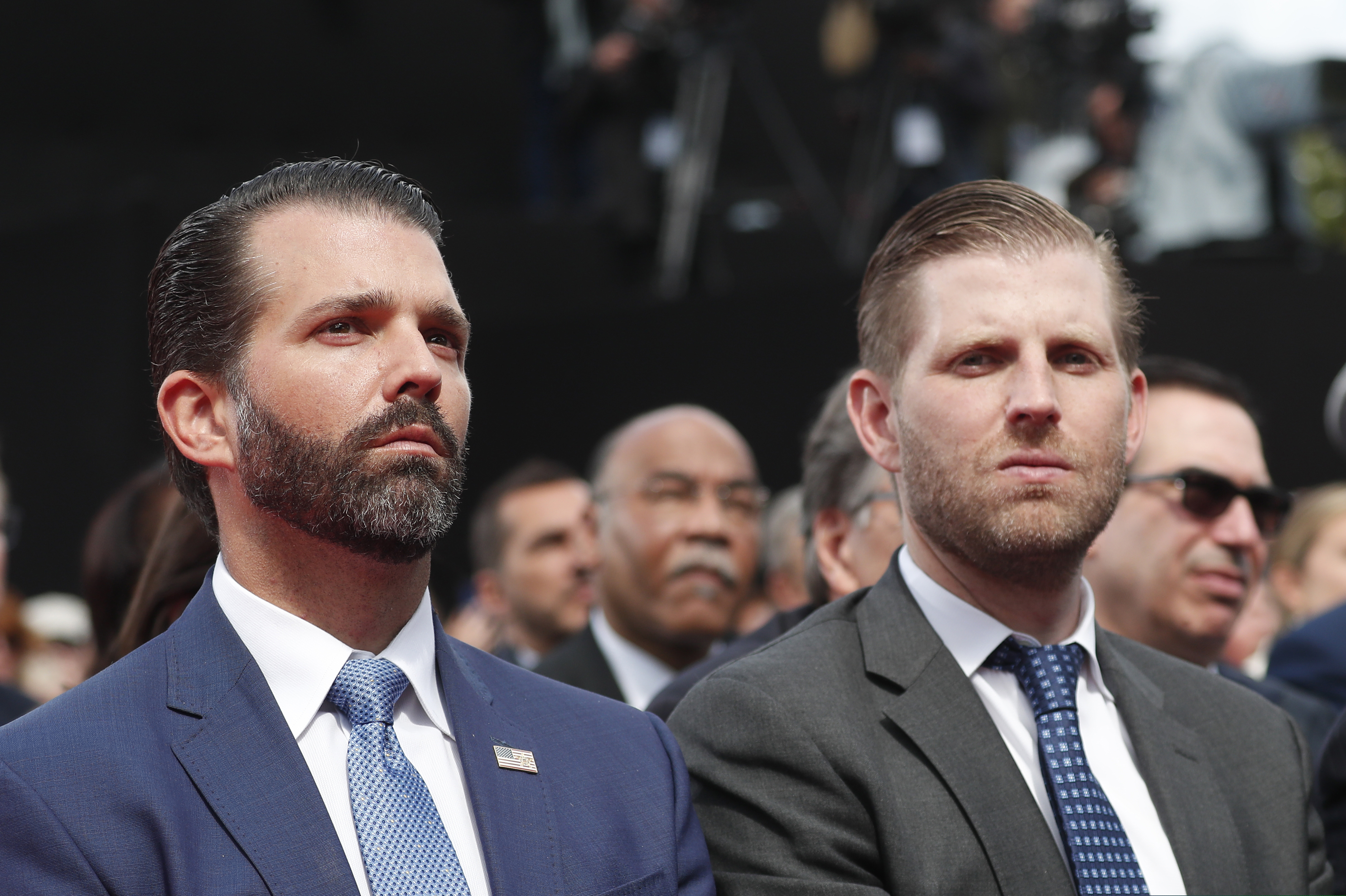 Donald Trump Jr., left, and Eric Trump attend a ceremony to mark the 75th anniversary of D-Day at the Normandy American Cemetery in Colleville-sur-Mer, Normandy, France, Thursday, June 6, 2019. World leaders are gathered Thursday in France to mark the 75th anniversary of the D-Day landings. Man at left is unidentified. (Ian Langsdon/POOL via AP)