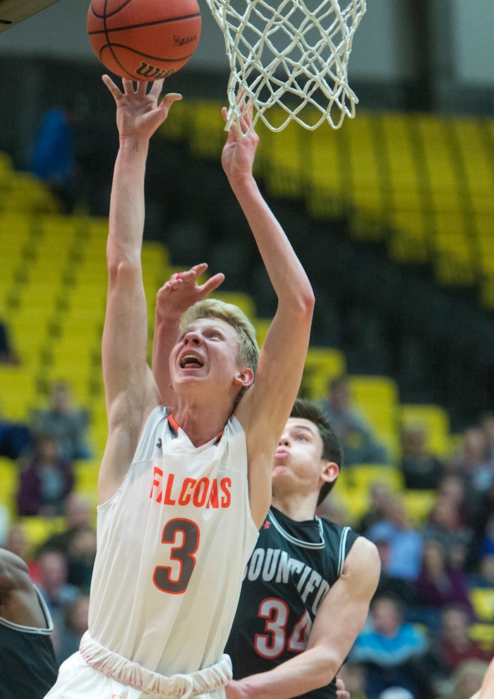 (Rick Egan  |  The Salt Lake Tribune)   Skyridge Falcons Duncan Reid (3) shoots as Bountiful Braves Cooper Ohlson (34) defends, in 5A basketball playoff action between the Bountiful Braves and Skyridge Falcons, at the UCCU Center in Orem, Monday, Feb. 26, 2018.