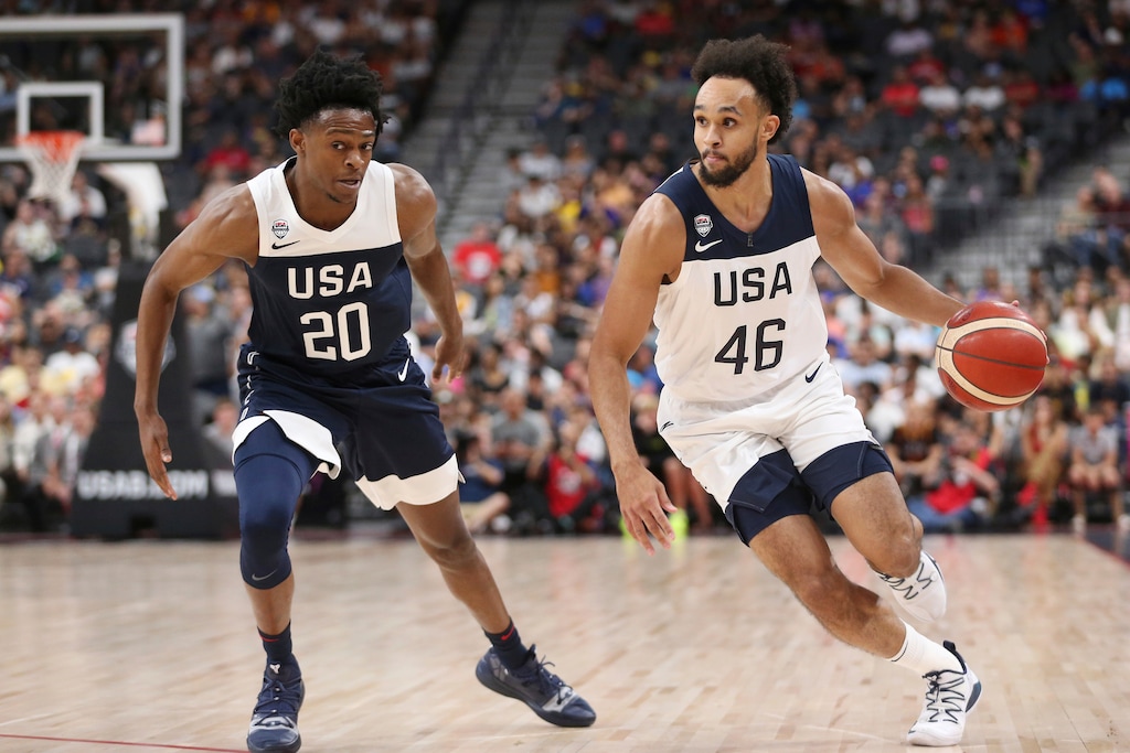 Team White guard Derrick White (46) dribbles the ball past Team Blue guard De'Aaron Fox (20) during the first half of the U.S. men's basketball team's scrimmage in Las Vegas, Friday, Aug. 9, 2019. (Erik Verduzco/Las Vegas Review-Journal via AP)