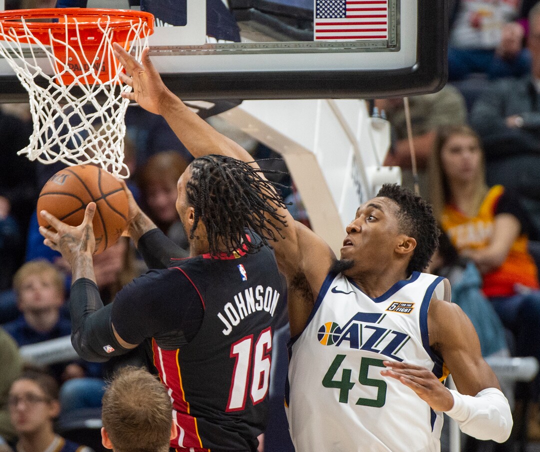 (Rick Egan  |  The Salt Lake Tribune)     Utah Jazz guard Donovan Mitchell (45) stops Miami Heat forward James Johnson (16) from scoring, but is called for a foul on the play, in NBA action between Utah Jazz and Miami Heat, at Vivint Smart Home Arena Wednesday, Dec. 12, 2018.