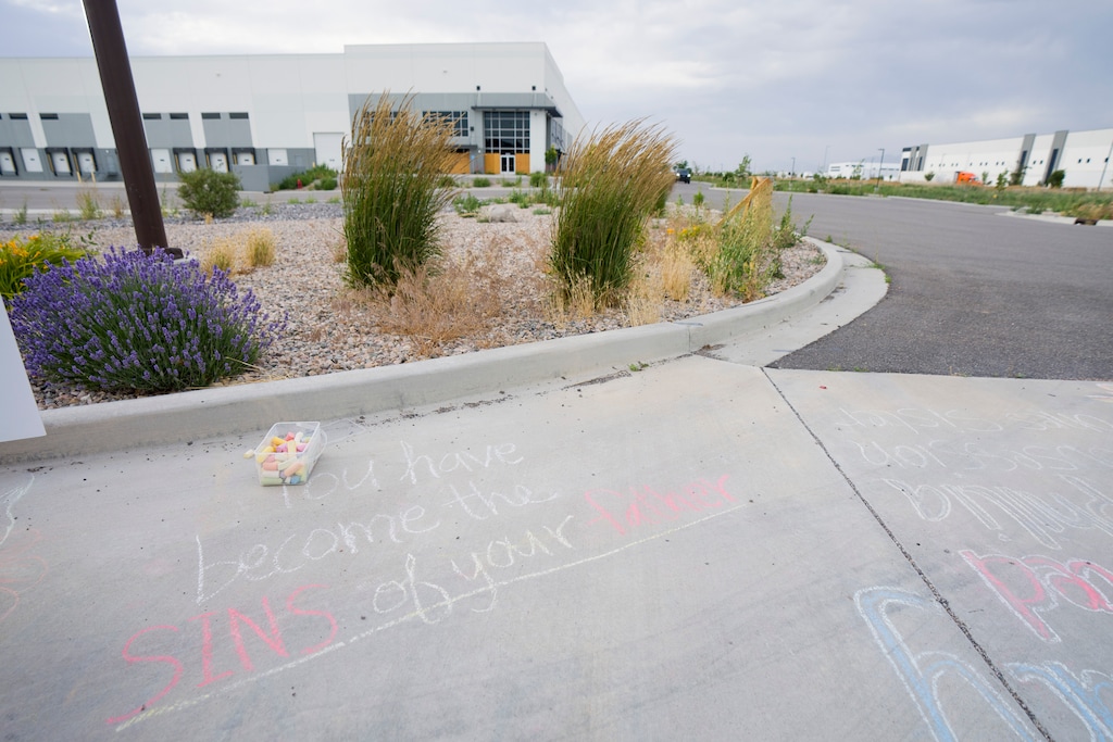 (Bethany Baker | The Salt Lake Tribune) Messages are written on the ground as people protest outside of a proposed Immigration and Customs Enforcement detention center in Salt Lake City on Saturday, June 6, 2026. Salt Lake City and Salt Lake County are suiting to stop the planned center.