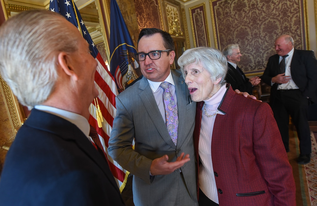 (Francisco Kjolseth  |  The Salt Lake Tribune)  Senate President Wayne Niederhauser, left, and House speaker Greg Hughes joke around with champion for the homeless Pamela Atkinson following the signing of  H.B. 472 - Medicaid Expansion Revisions, which would expand Medicaid healthcare coverage to cover an additional 60,000 Utahns below the poverty line — pending approval from the federal government. The bill was signed by Gov. Gary Herbert at the Utah Capitol on Tuesday, March 27, 2018.