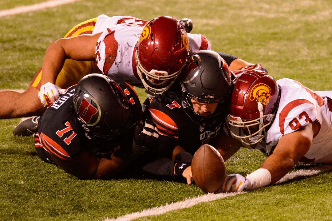 (Trent Nelson  |  The Salt Lake Tribune) Utah Utes quarterback Cameron Rising (7) tries to recover the ball he fumbled as he's hit by USC Trojans defensive lineman Marlon Tuipulotu (93), as the Utah Utes host the USC Trojans, NCAA football at Rice-Eccles Stadium in Salt Lake City on Saturday, Nov. 21, 2020.