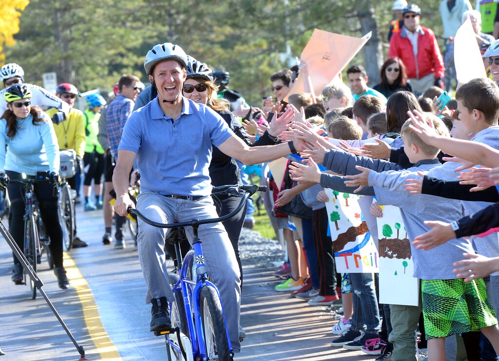 (Al Hartmann  |  The Salt Lake Tribune) 	
 Juan Arce-Larreta, chair of Parleys Rails Trails and Tunnels Coalition, takes the first official ride to open a long section of Parleys Trail at Tanner Park Tuesday Oct. 17. Rosecrest Elementary fourth graders greet him with a wall of high fives. 
Made possible by the 2012 Parks and Trails bond initiative, completion of these phases means eight miles of the trail is now complete from the Bonneville Shoreline to 900 West.