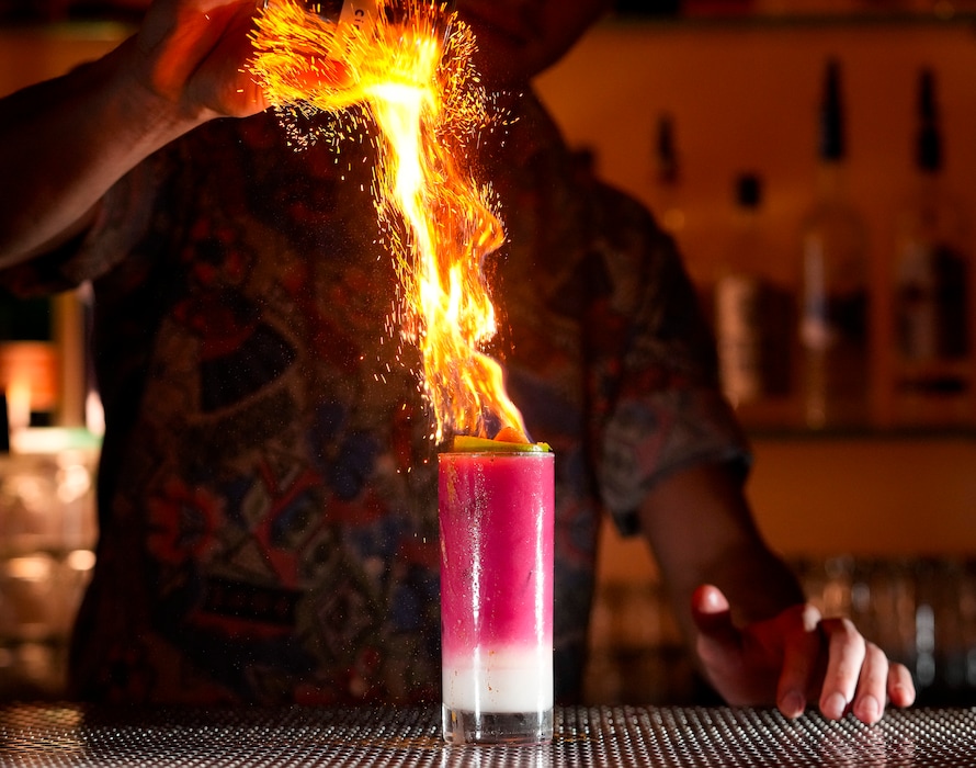 (Bethany Baker  |  The Salt Lake Tribune) Eric Lewis pours cinnamon over a craft mocktail drink for a fiery effect at Bar X in Salt Lake City on Thursday, Jan. 11, 2024.