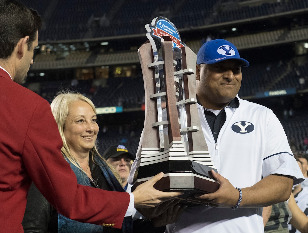 Rick Egan  |  The Salt Lake TribuneBrigham Young Cougars head coach Kalani Sitake holds the trophy after BYU defeated Wyoming 24-21in the Poinsettia Bowl, at Qualcomm Stadium in San Diego, December 21, 2016.