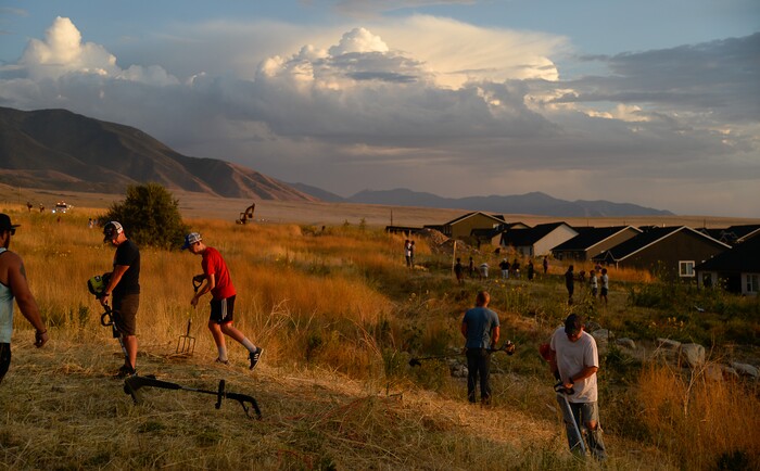 (Francisco Kjolseth  |  The Salt Lake Tribune)  The community comes together to reduce dry fuels behind their houses as crews battle a grass fire in Tooele county being dubbed the Green Ravine fire as it burns on Tuesday, Sept. 3, 2019.