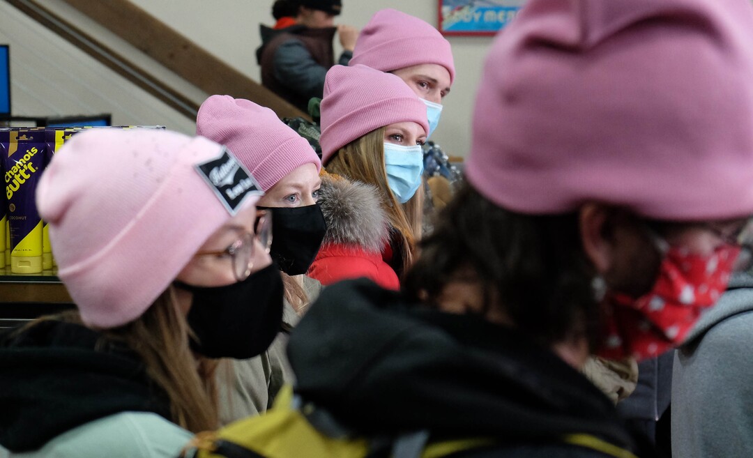 (Francisco Kjolseth  | The Salt Lake Tribune) People gather in a big circle at Hangar 15 bicycle shop in Millcreek to tell stories of Louis Holian, Sarah Moughamian and Thomas Steinbrecher on Sunday, Feb. 14, 2021, three of the four who died in an avalanche on Saturday, Feb. 6. Louis who loved the color pink was honored by many wearing pink hats. Stephanie Hopkins who was in a different group that day was swept up in the same avalanche.