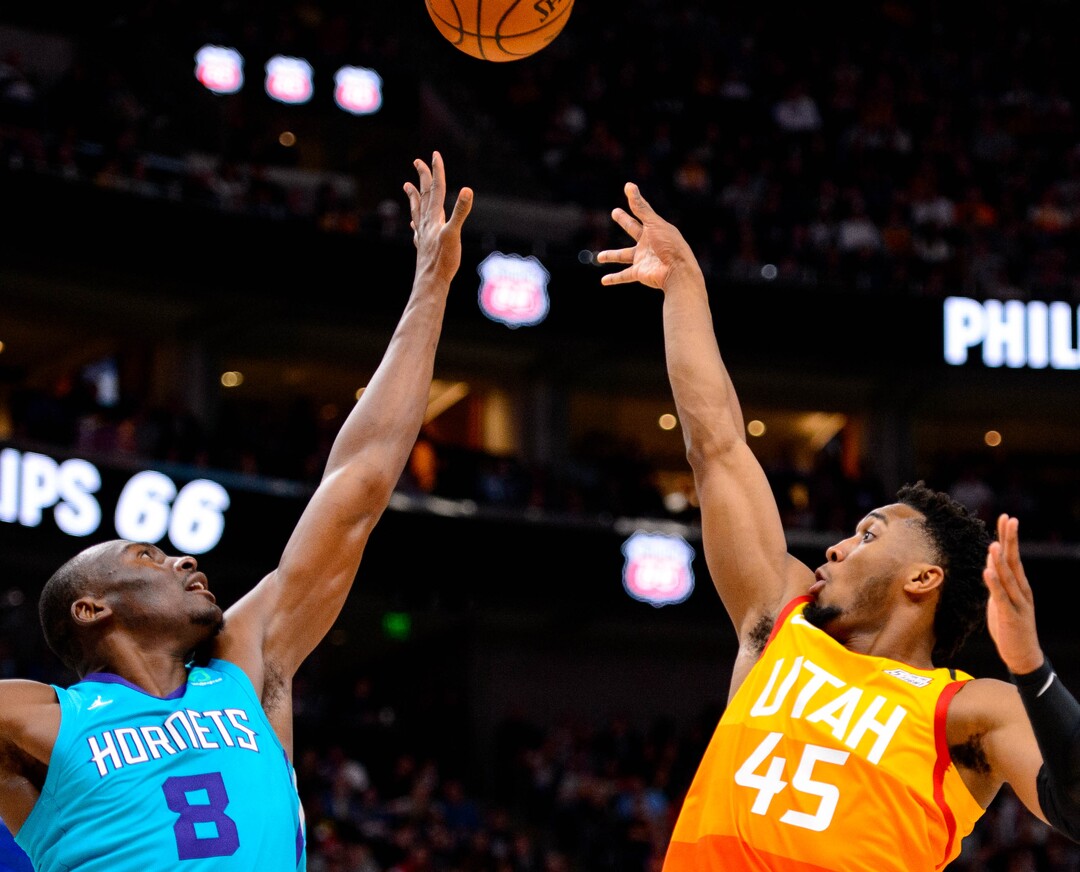 (Trent Nelson  |  The Salt Lake Tribune) Utah Jazz guard Donovan Mitchell (45) shoots over Charlotte Hornets center Bismack Biyombo (8) as the Utah Jazz host the Charlotte Hornets, NBA basketball in Salt Lake City on Friday, Jan. 10, 2020.