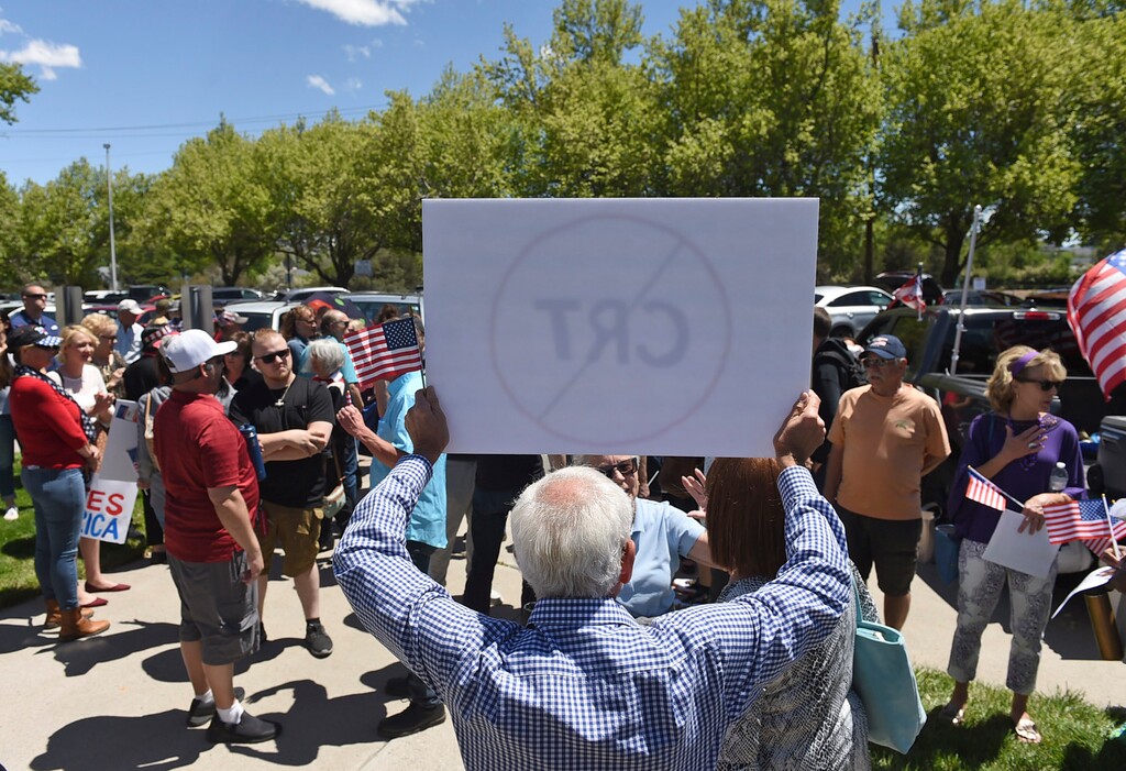 (Andy Barron | Reno Gazette-Journal via AP)  A man holds up a sign against critical race theory during a protest outside a Washoe County School District board meeting on May 25, 2021, in Reno, Nev.