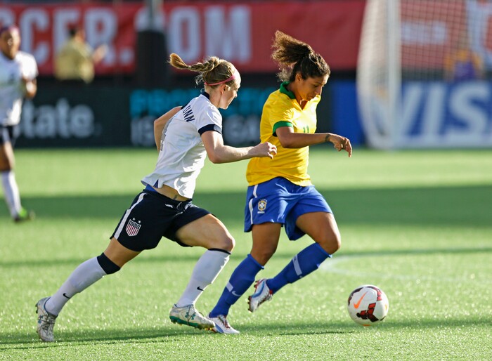 U.S. defender Becky Sauerbrunn (4) tries to get control of the ball away from Brazil forward Cristiane (11) during the first half of an international friendly soccer match in Orlando, Fla., Sunday, Nov. 10, 2013.(AP Photo/John Raoux)