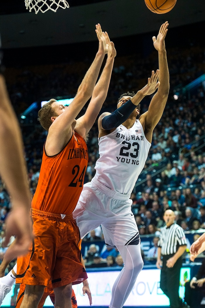 (Chris Detrick  |  The Salt Lake Tribune)  Brigham Young Cougars forward Yoeli Childs (23) shoots past Idaho State Bengals forward Blake Truman (24) during the game at the Marriott Center Thursday, December 21, 2017.  