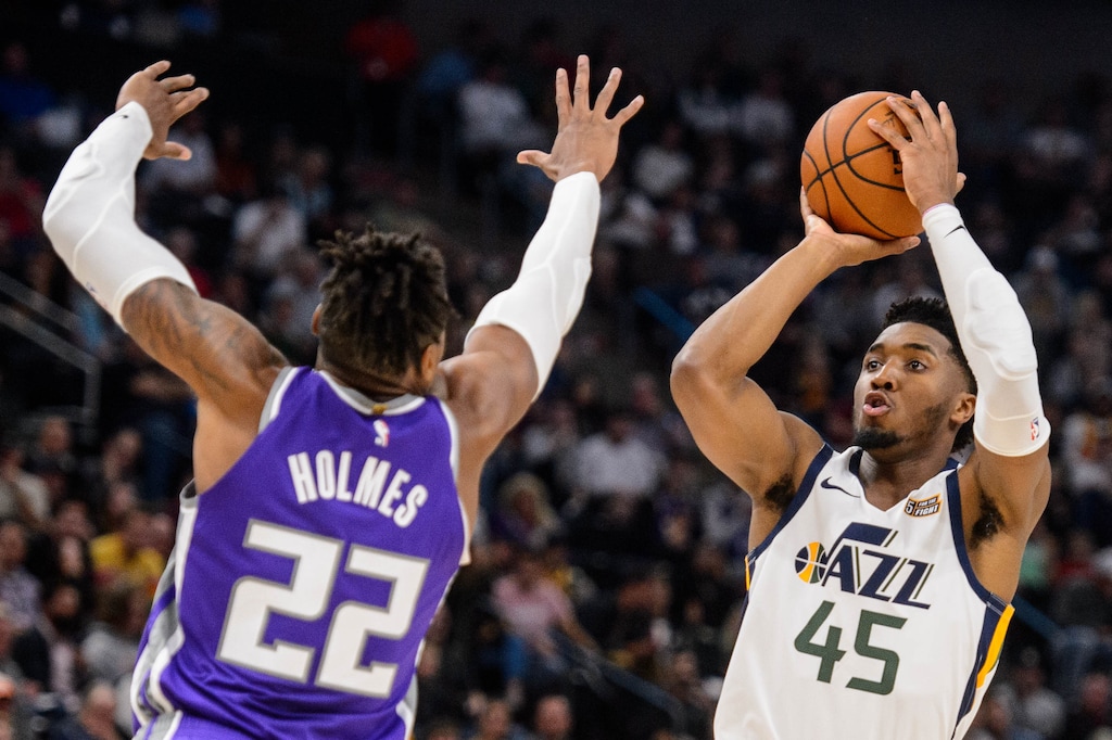 (Trent Nelson  |  The Salt Lake Tribune) Utah Jazz guard Donovan Mitchell (45) shoots over Sacramento Kings forward Richaun Holmes (22) as the Utah Jazz hosts the Sacramento Kings, NBA basketball in Salt Lake City on Monday Oct. 14, 2019.