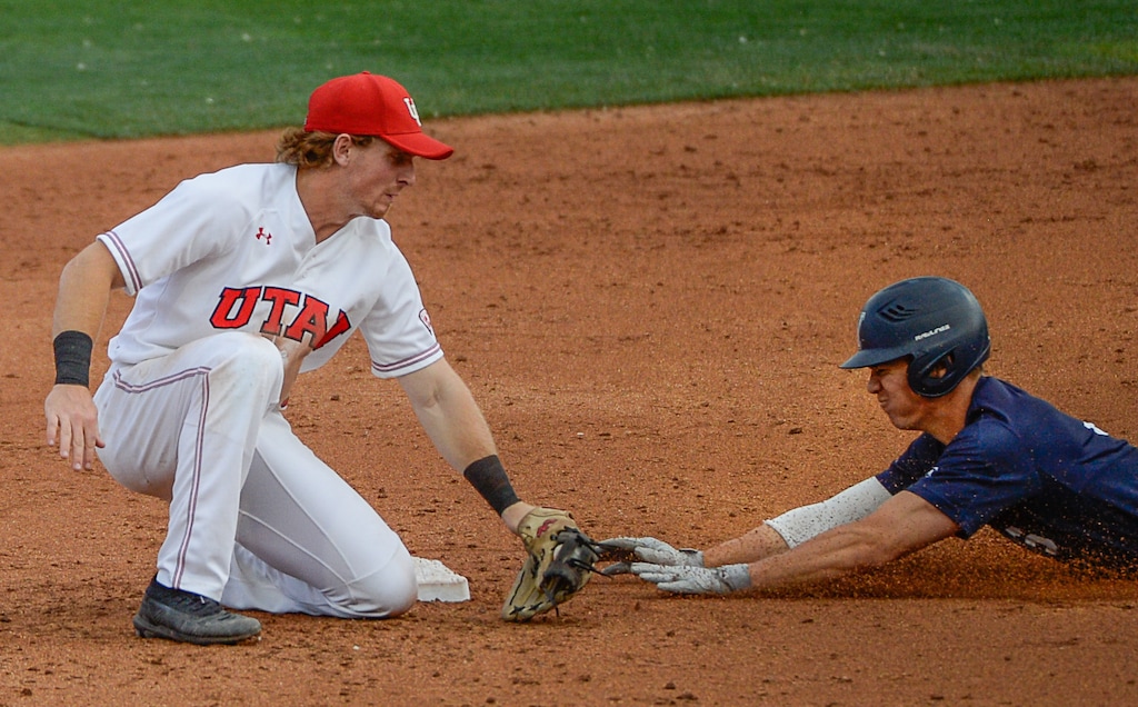 (Francisco Kjolseth  |  The Salt Lake Tribune)  Oliver Dunn denies a second base steal attempt by Danny Gelalich as Utah and BYU renew their rivalry on the baseball diamond as they battle it out at Smith's Ballpark in Salt Lake City on Tuesday, May 14, 2019.