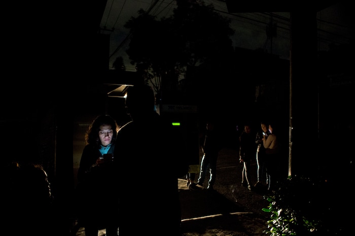 People who evacuated from bars stand in the street in La Roma neighborhood of Mexico City, after an earthquake shook buildings forcefully and knocked out power in the area, just after midnight on Friday, Sept. 8, 2017. A massive 8-magnitude earthquake hit off the coast of southern Mexico late Thursday night, causing buildings to sway violently and people to flee into the street in panic as far away as the capital city.(AP Photo/Rebecca Blackwell)