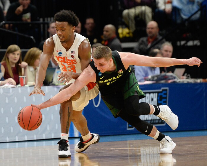 (Francisco Kjolseth  |  The Salt Lake Tribune)  Syracuse Orange forward Elijah Hughes (33) and Baylor Bears guard Makai Mason (10) battle over a ball as Syracuse faces Baylor in their first round menÕs NCAA March Madness tournament game at Vivint Smart Home Arena in Salt Lake City on Thursday, March 21, 2019.