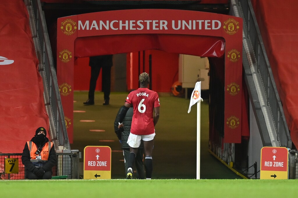 Manchester United's Paul Pogba walks off the pitch into the tunnel after getting injured during an English Premier League soccer match between Manchester United and Everton at the Old Trafford stadium in Manchester, England, Saturday Feb. 6, 2021. (Michael Regan/Pool via AP)
