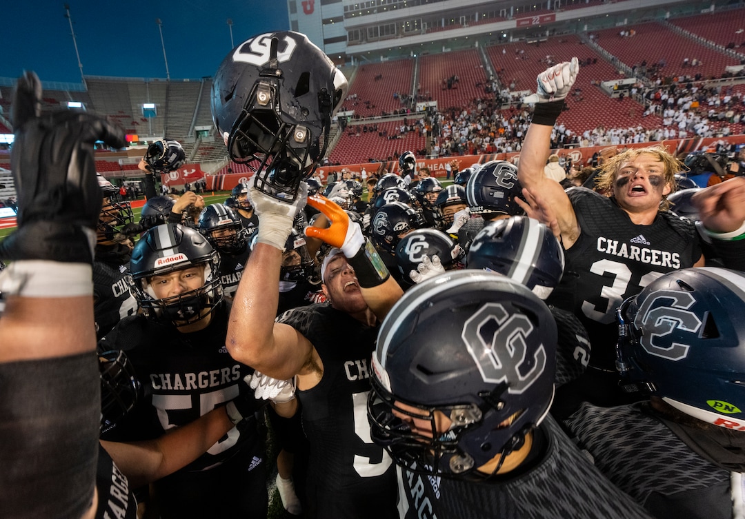 (Rick Egan | The Salt Lake Tribune) The Corner Canyon Chargers celebrate their win over the Skyridge Falcons, for the 6A State championship at Rice-Eccles Stadium, on Friday, Nov. 17, 2023.