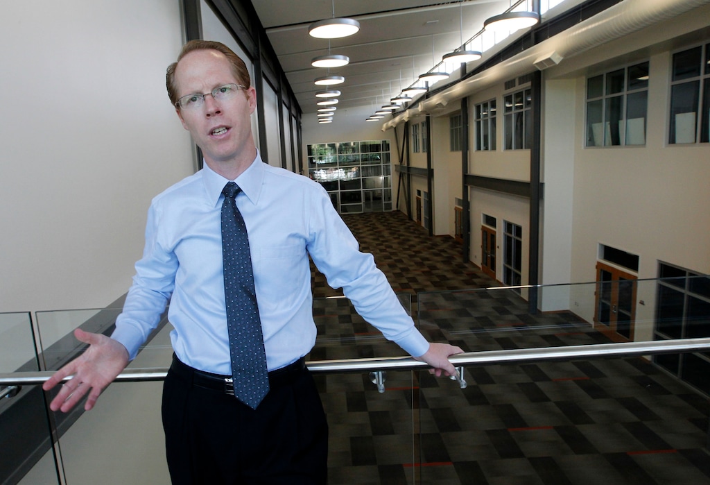 (Al Hartmann  |  Tribune file photo)
Then-Principal Kenneth Grover shows the atrium area of the soon-to-open Innovations High School at 1700 S. State St. The school is next door to the Salt Lake Community College campus, where high school students can take advantage of the library and even some college classes.