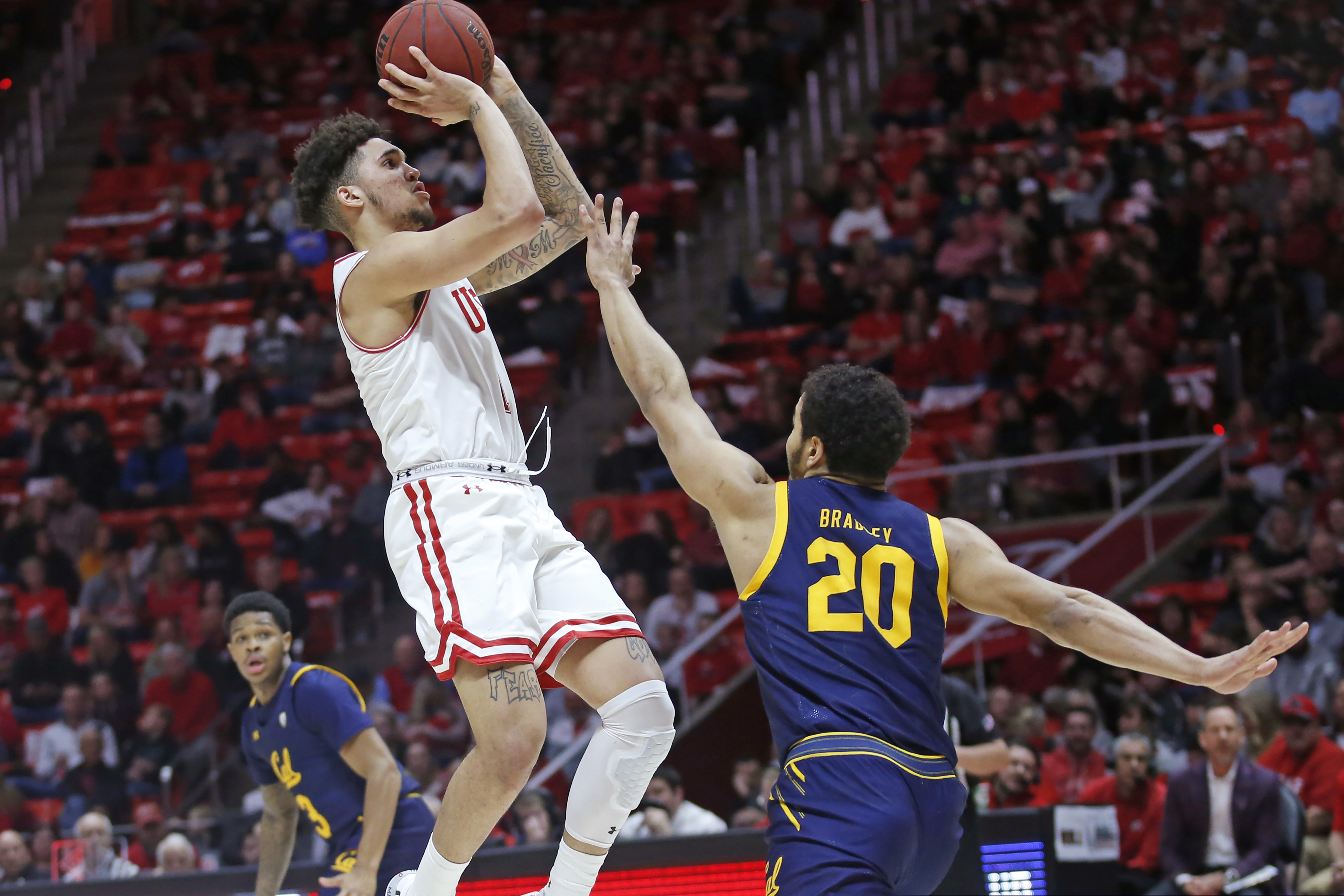 FILE - In this Feb. 8, 2020, file photo, Utah forward Timmy Allen shoots as California guard Matt Bradley (20) defends during the second half of an NCAA college basketball game in Salt Lake City. Allen is testing the NBA waters. The do-everything guard from Mesa, Ariz., joined teammate Both Gach among the 205 players on the league's most recent early-entry draft list. (AP Photo/Rick Bowmer, File)