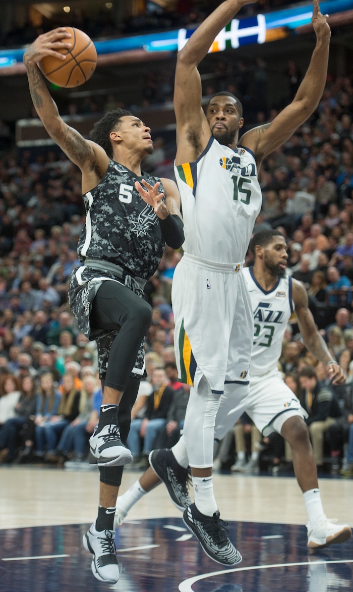 (Rick Egan  |  The Salt Lake Tribune)  San Antonio Spurs guard Dejounte Murray (5) takes the ball to the hoop, as Utah Jazz forward Derrick Favors (15) defends, in NBA action Utah Jazz vs San Antonio Spurs in Salt Lake City, Monday, February 12, 2018.