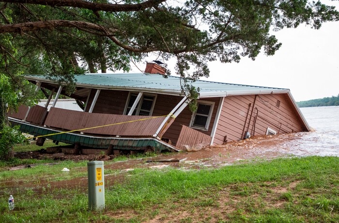 (Chris Landsberger/The Oklahoman via AP) Flood waters from the Cimarron River wash away a home in the Twin Lakes community near Cimarron City, Okla. on Wednesday, May 22, 2019.