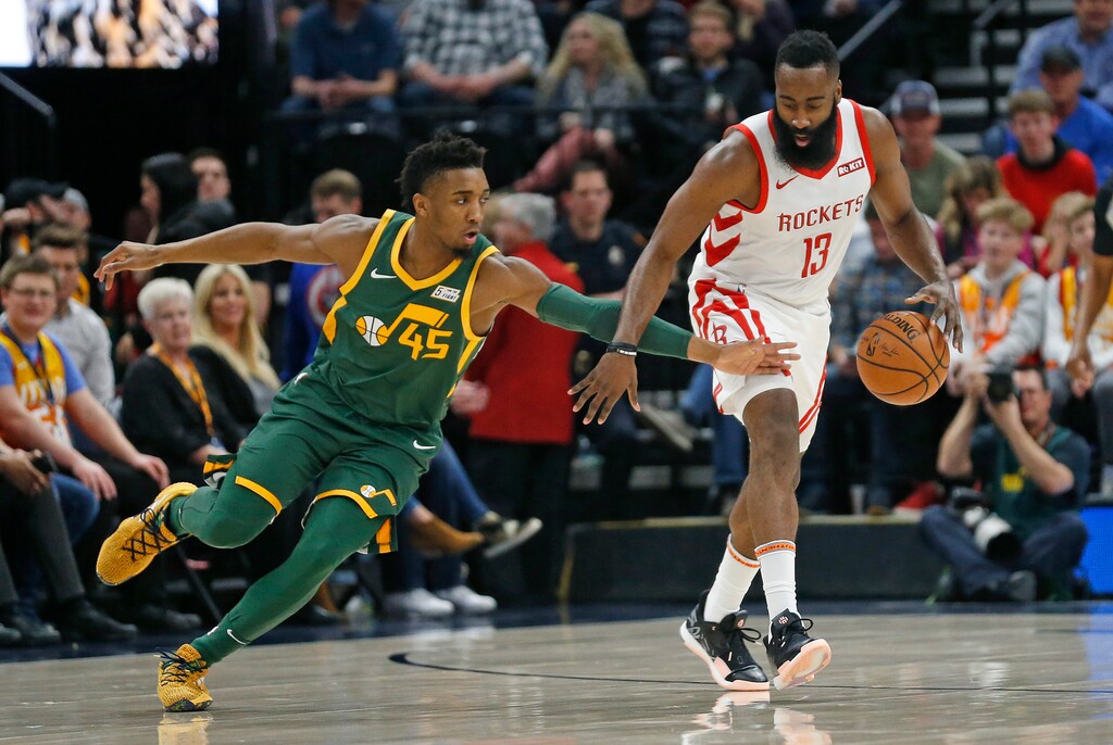 Utah Jazz guard Donovan Mitchell (45) reaches for the ball as Houston Rockets guard James Harden (13) brings it upcourt during the first half of an NBA basketball game Saturday, Feb. 2, 2019, in Salt Lake City. (AP Photo/Rick Bowmer)