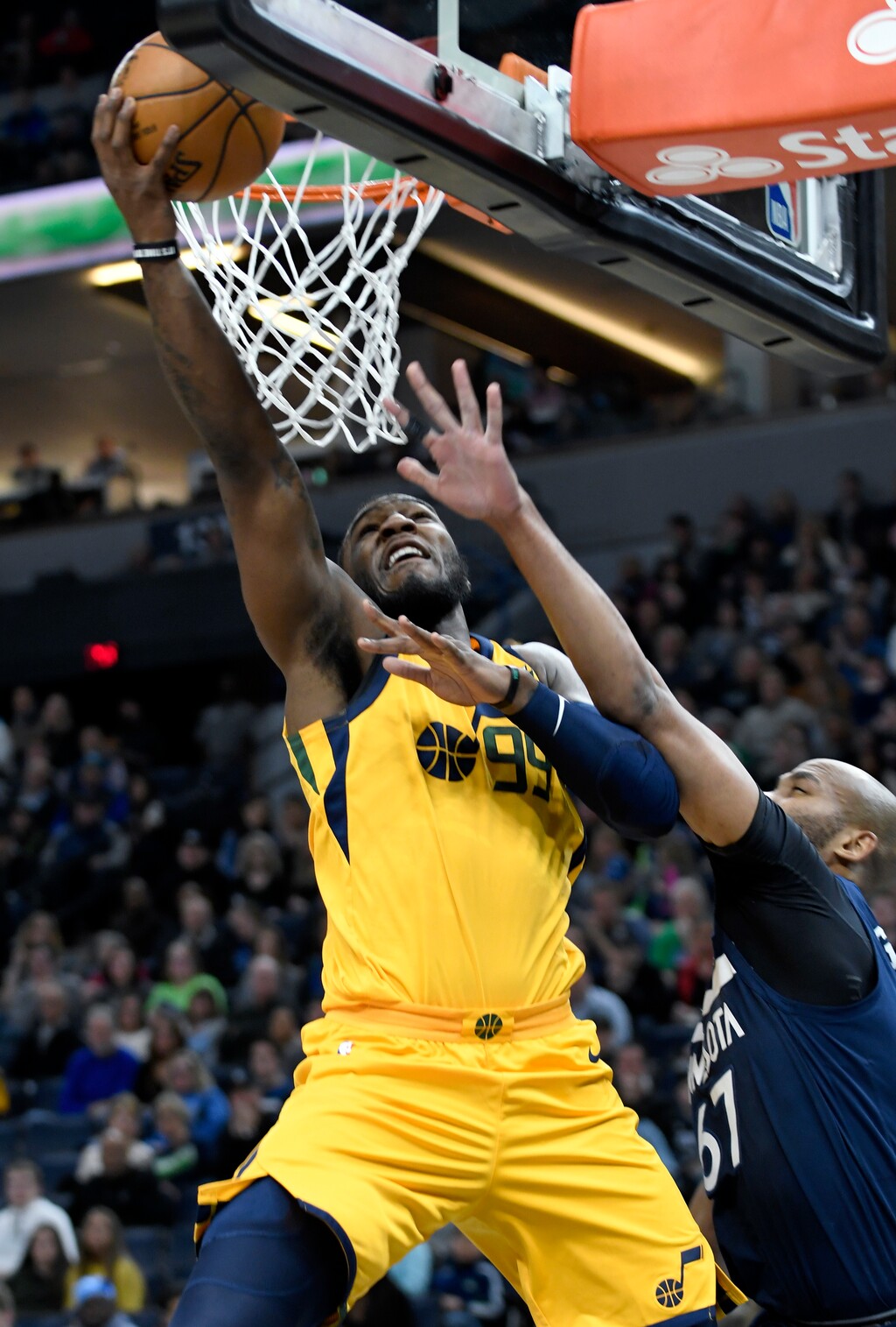 Utah Jazz's Jae Crowder, left, goes to the basket past Minnesota Timberwolves' Taj Gibson during the second quarter of an NBA basketball game Sunday, April 1, 2018, in Minneapolis. (AP Photo/Tom Olmscheid)
