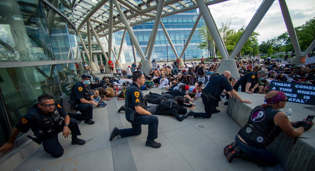 (Rick Egan  |  The Salt Lake Tribune)     Police Chief Mike Brown and some of his officers kneel down in silence along with the crowd for 9 minutes in memory of George Floyd, during a demonstration at the Public Safety Building, Wednesday, June 3, 2020.