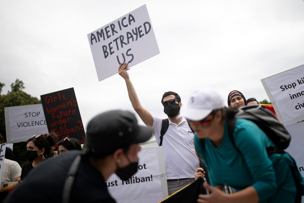 (Tom Brenner | The New York Times)

Demonstrators near the White House as Taliban fighters seize the capital city of Kabul, Afghanistan on Sunday, Aug. 15, 2021. President Joe Biden's decision not to begin a mass evacuation of Afghans months ago has left tens of thousands of people in a desperate limbo.