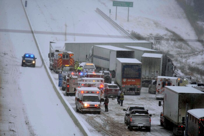 Emergency personnel remove patients for transport to area hospitals at the scene of a multi-vehicle wreck on Interstate 65 near Bonnieville, Ky., Tuesday, Jan. 16, 2018. The wreck shut down the southbound lanes for several hours. Several people were transported from the scene to at least two different hospitals.  (Neal Cardin/The News-Enterprise via AP)