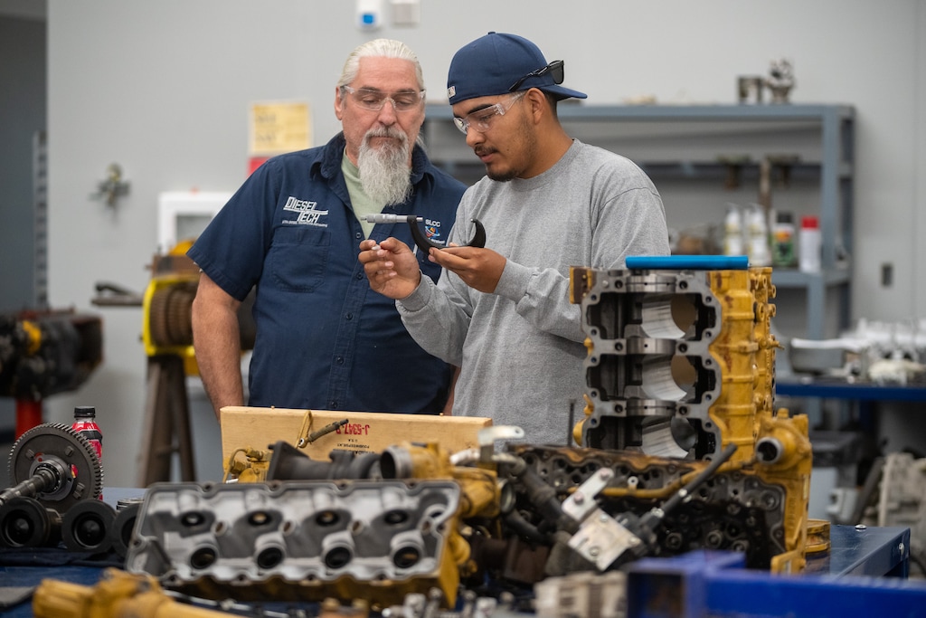 (Trent Nelson | The Salt Lake Tribune) Instructor Jeff Mulligan and student Alvaro Huizar work in a diesel systems technology course at Salt Lake Technical College on Thursday, Sept. 8, 2022.