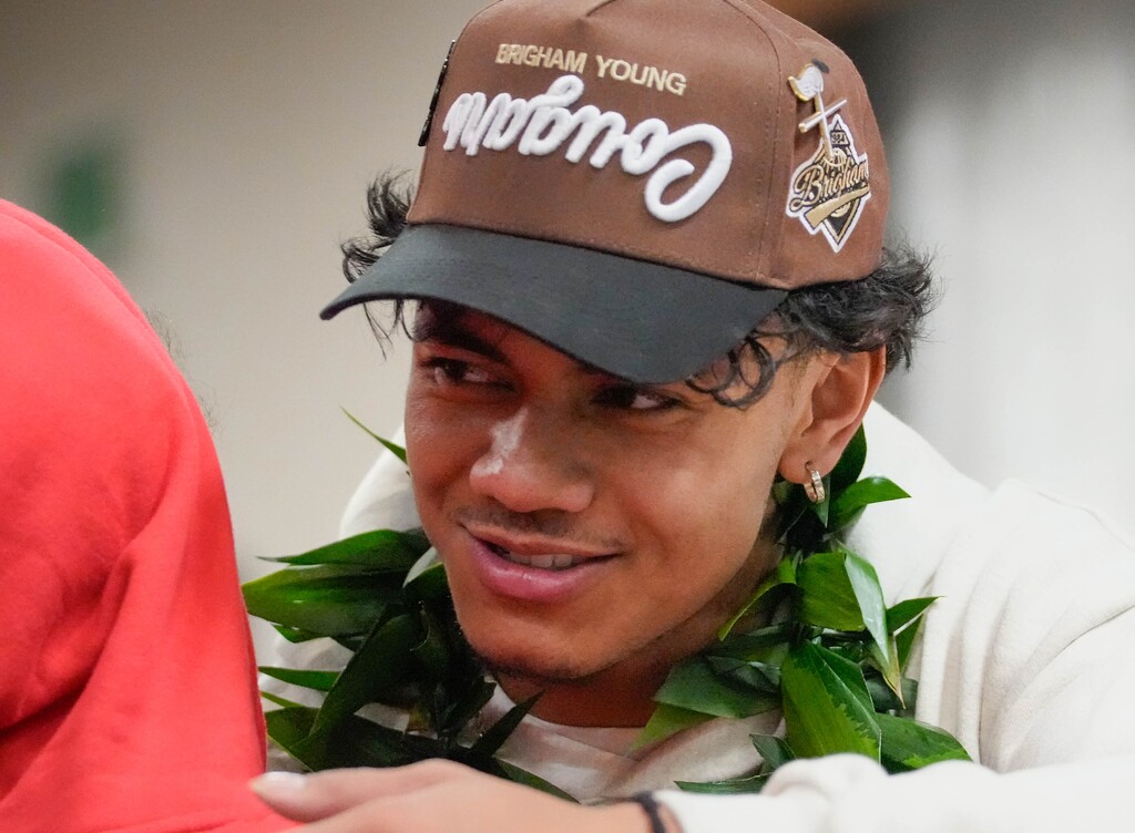 (Francisco Kjolseth  |  The Salt Lake Tribune) Ephraim Asiata, a top 15 player in Utah, is embraced by friends and family in West Jordan on Tuesday, Dec. 19, following his c commitment announcement to play football for BYU.
