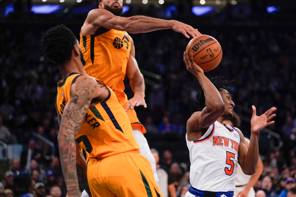 New York Knicks' Immanuel Quickley, right, tries to get a pass off during the first half of an NBA basketball game against the Utah Jazz, Sunday, March 20, 2022, in New York. (AP Photo/Seth Wenig)