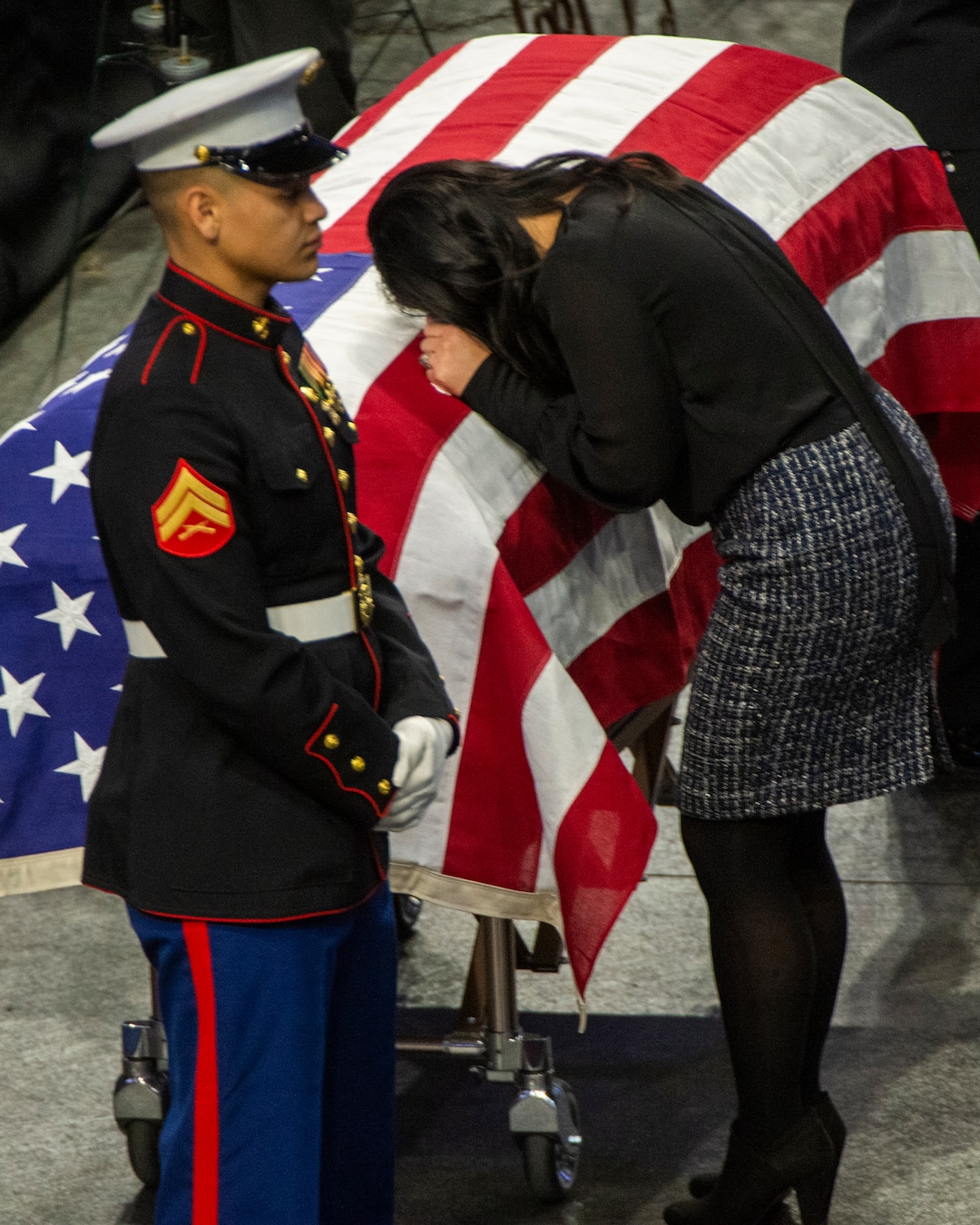 (Rick Egan  |  The Salt Lake Tribune)     Elizabeth Romrell spends a moment  by the casket of her husband, South Salt Lake police officer, David Romrell, before his funeral at the Maverik Center, in West Valley City, Wednesday, Dec. 5, 2018.