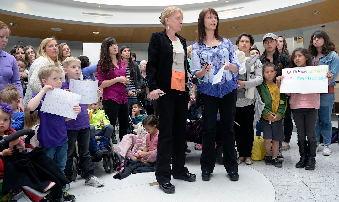 (Al Hartmann  |  The Salt Lake Tribune)  Judi Hilman with Salt Lake Indivisible, left center, and Sharlee Glenn with Mormon Women for Ethical Government gathered with Mormon women and other concerned citizens at the Salt Lake City Airport in a show of solidarity for an area woman, Isabel, who has been ordered to leave the United States by ICE agents. 
ICE  escorted her onto a flight bound for Columbia. Isabel is a single mother and is the sole caretaker for her disabled son and her 86-year-old mother.