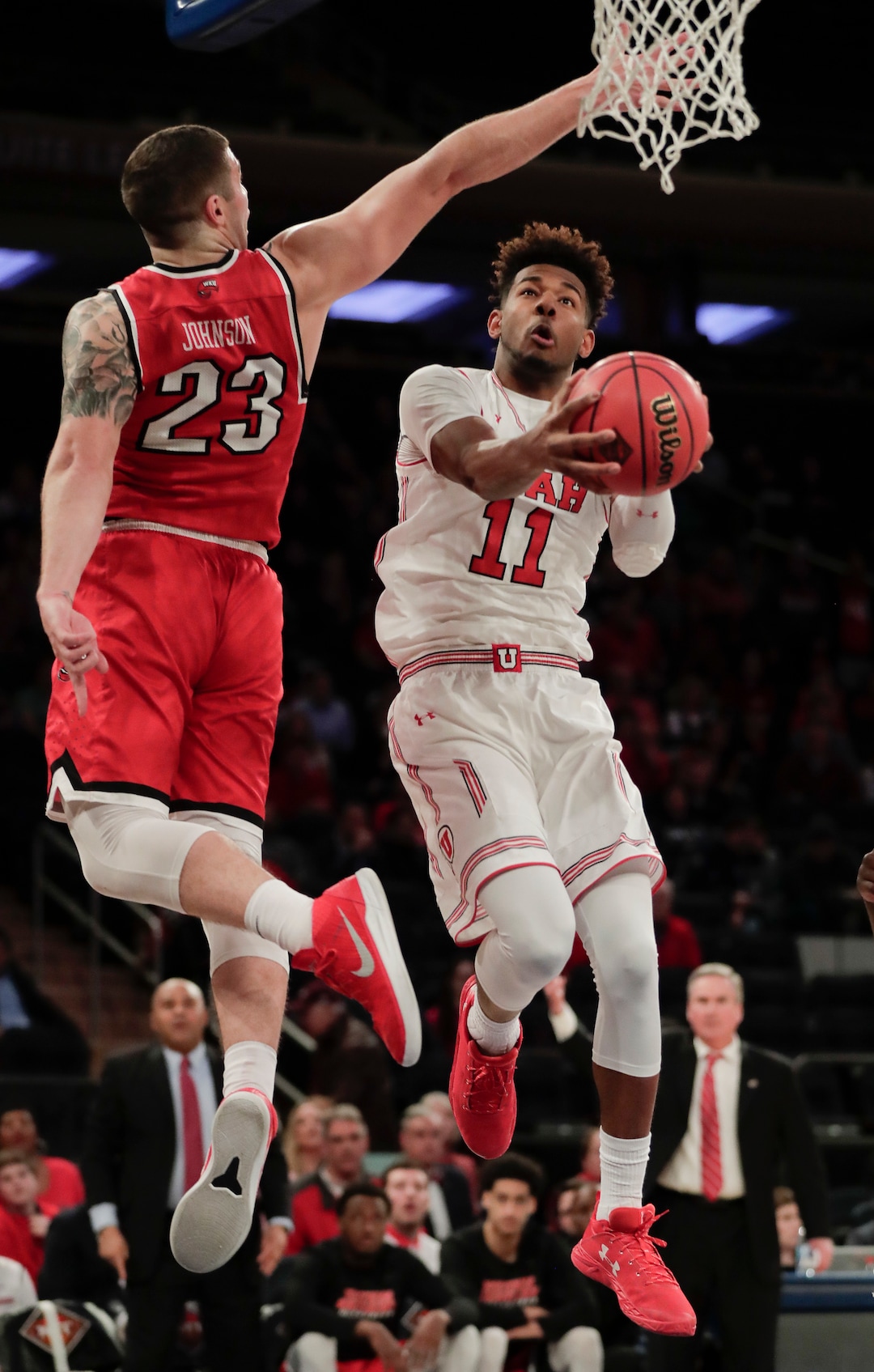 Utah forward Chris Seeley (11) shoots against Western Kentucky forward Justin Johnson (23) during the first half of an NCAA college basketball game during the semifinals of the NIT Tuesday, March 27, 2018, in New York. (AP Photo/Julie Jacobson)