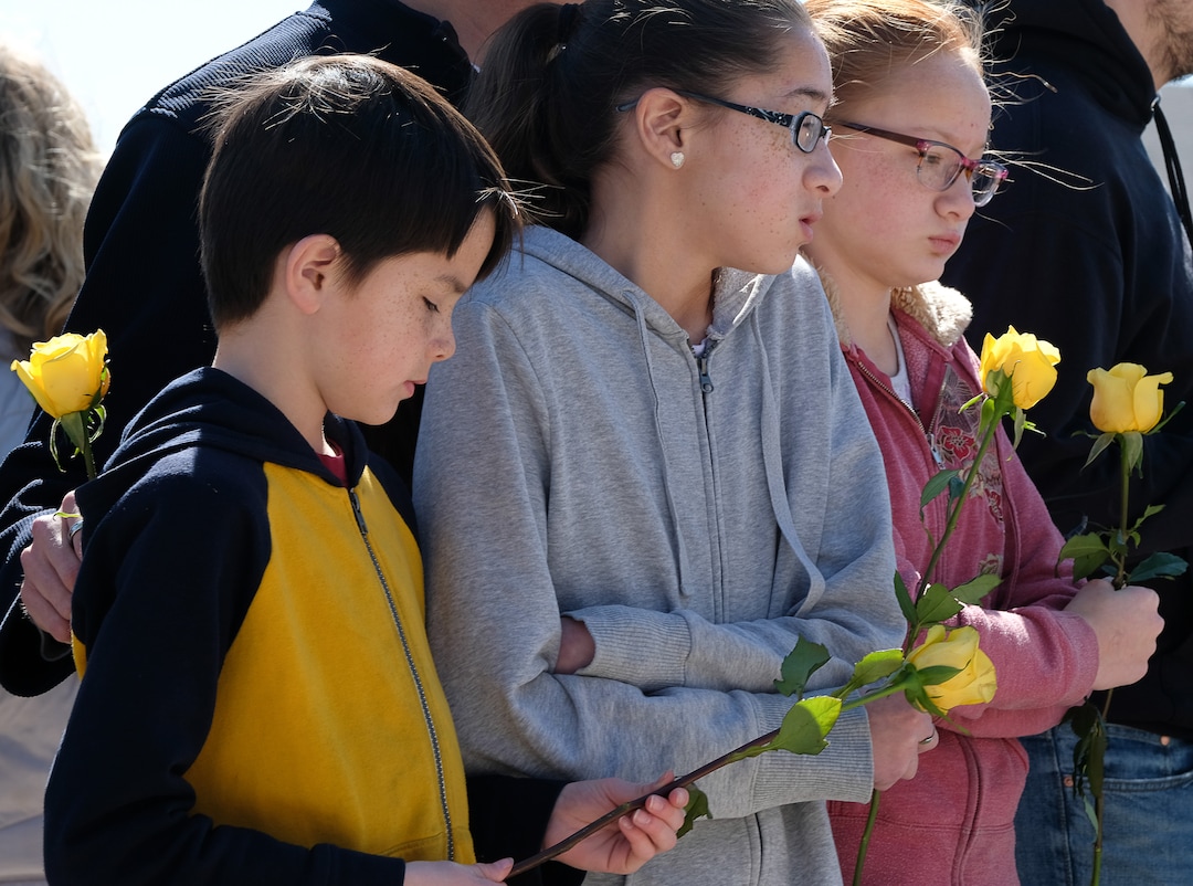 (Francisco Kjolseth  |  The Salt Lake Tribune)  Siblings Stockton, 9, Kadence, 13, and Tayah Smith, 11, of Spanish Fork hold flowers as they gather outside of the Al Sahaba Mosque in Orem waiting for members to conclude Friday prayers to show them love and support following the tragic shootings in New Zealand. 