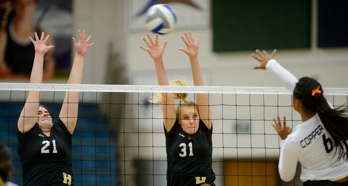 (Steve Griffin | The Salt Lake Tribune) Asiah Sopoaga of Copper Hills hits a shot through the Herriman defense during volleyball match at Copper Hills High School in West Jordan Tuesday September 26, 2017.