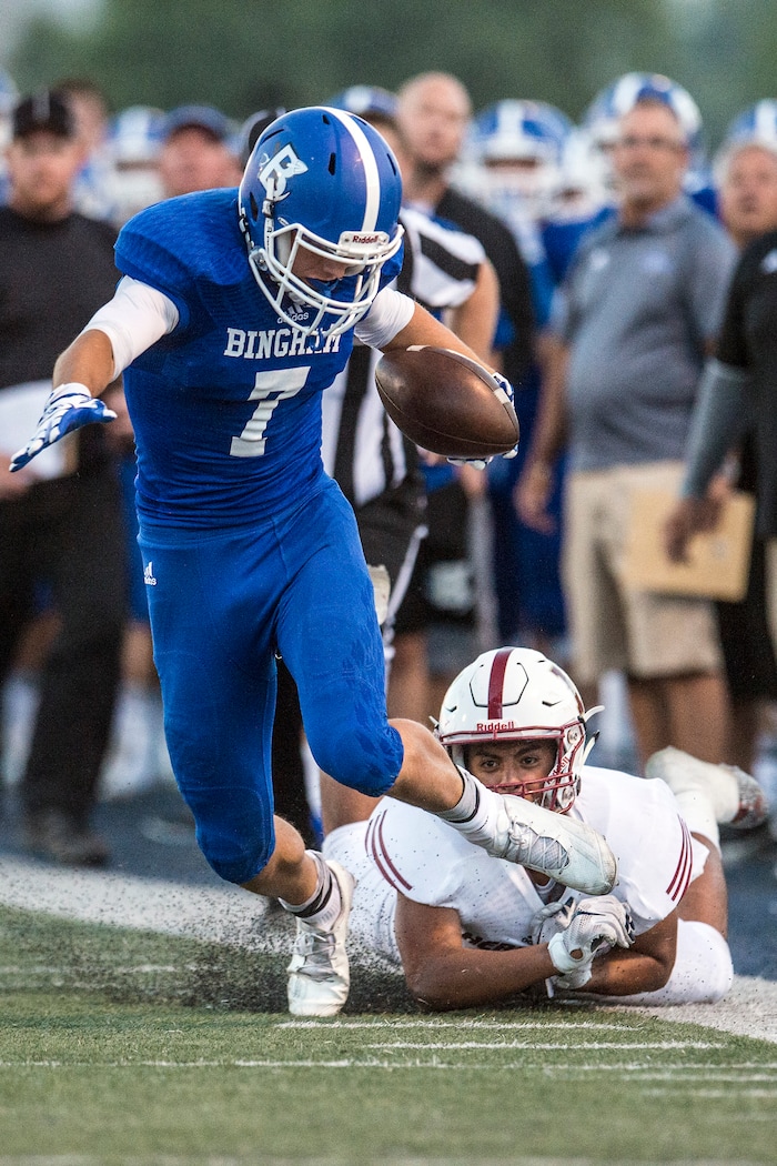 Chris Detrick | The Salt Lake Tribune
Bingham's Brayden Cosper (7) runs past Herriman's Sefanaia (Jr.) Leakehe (5) during the game at Bingham High School Friday August 26, 2016.